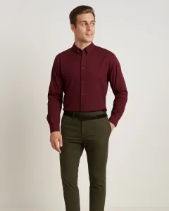 Man in dark pink shirt and green pants