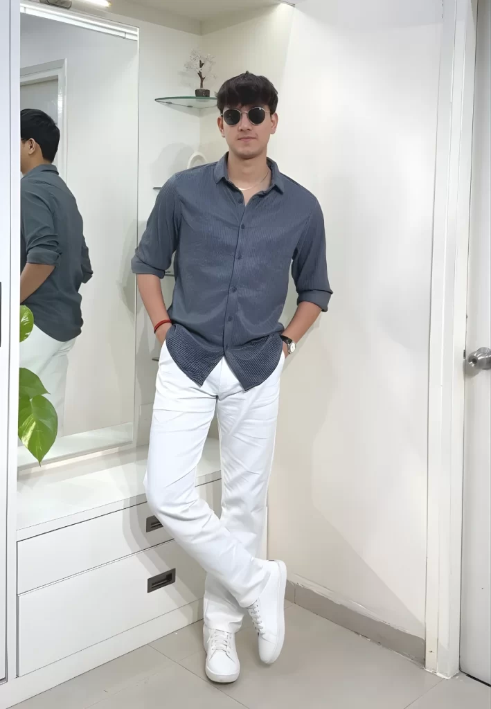 Man wearing grey shirt white trousers