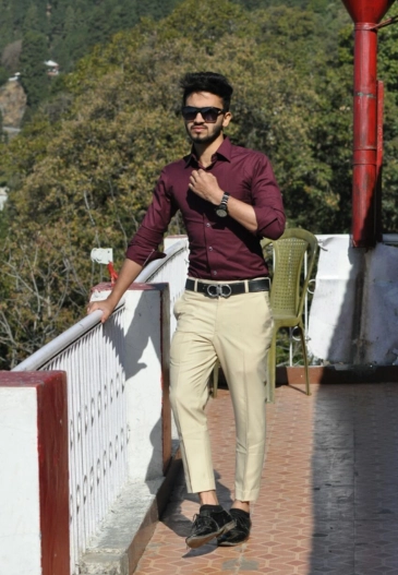 Man wearing maroon cream outfit