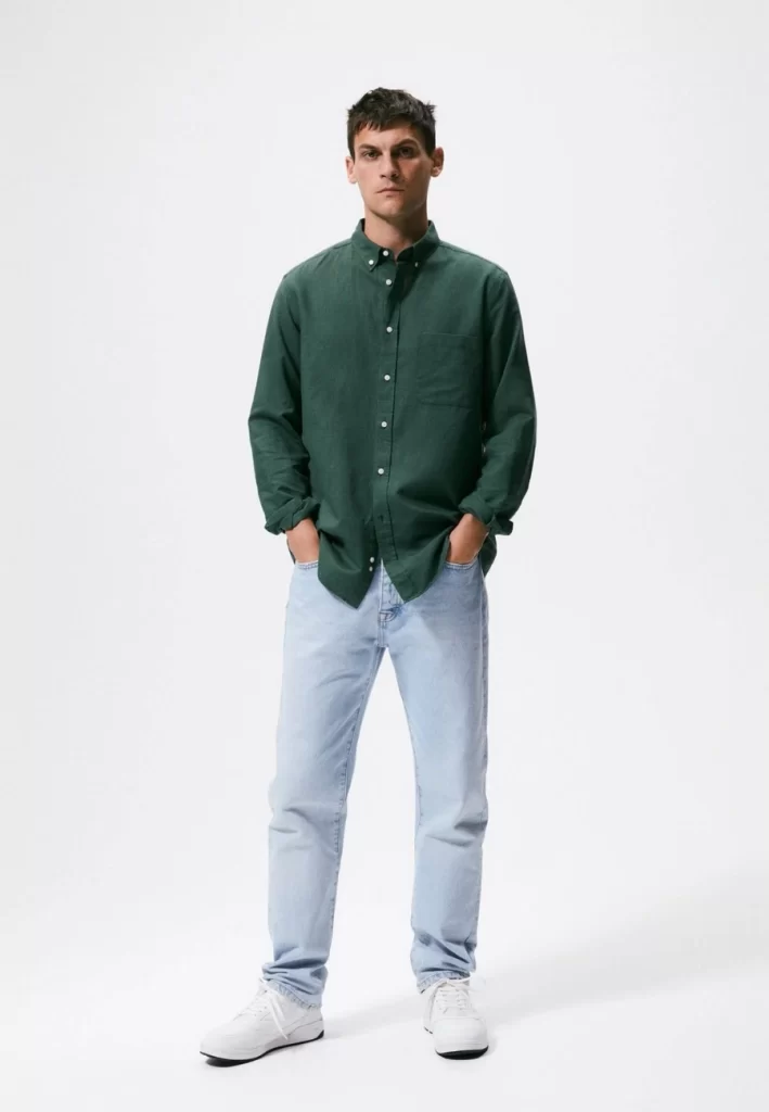 Dark green shirt with light jeans