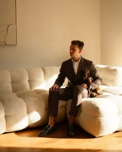 Man in brown suit sitting indoors